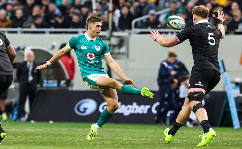 Ireland’s Jack Crowley chips over Fabian Holland of New Zealand during Saturday's Test match at Soldier Field. Photograph: Gary Carr/Inpho