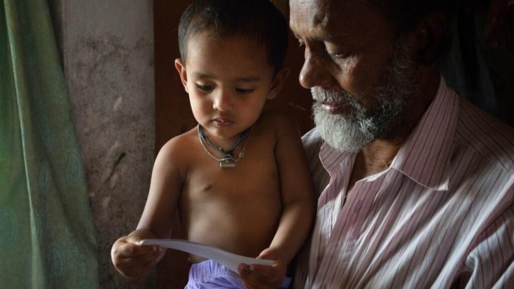 Seventeen-month-old Sheikh Rihan, seen with his grandfather, lost both parents in the collapse of the Rana Plaza last April. Photograph: Action Aid