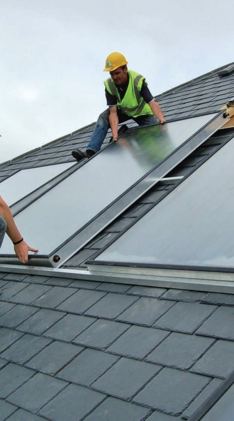 Workers install solar panels on a roof. Areas with newer builds have a higher proportion of A-rated homes. Photograph: courtesy of Construct Ireland