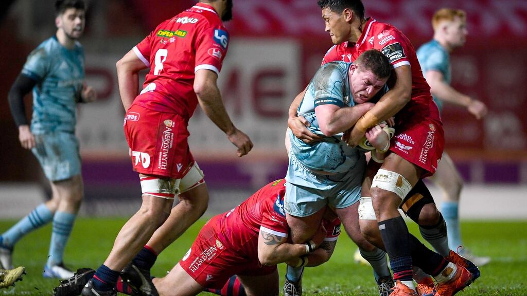 Leinster’s Tadhg Furlong is tackled by Phil Price and Sam Lousi of Scarlets during the Pro14 clash. Photo: Ryan Hiscott/Inpho