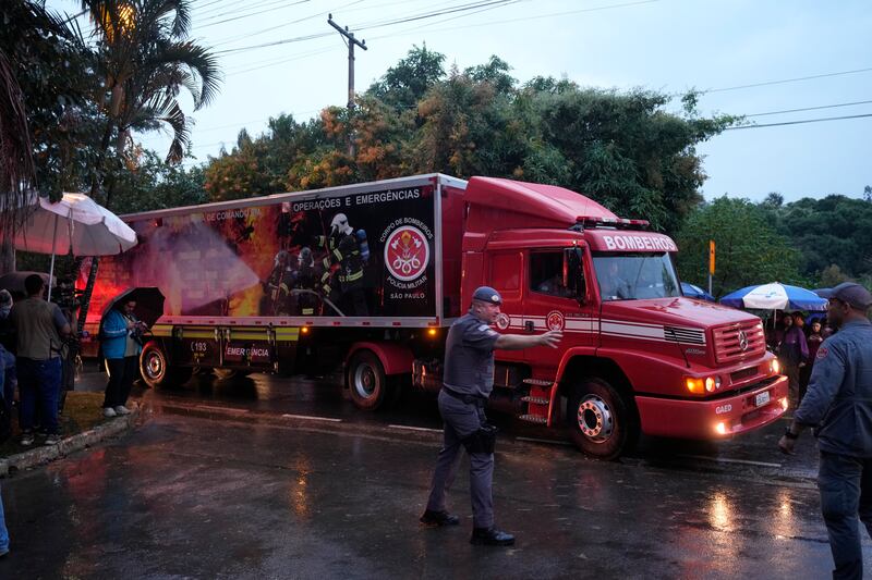 Emergency personnel after a plane carrying 61 people crashed. Photograph: Andre Penner/AP