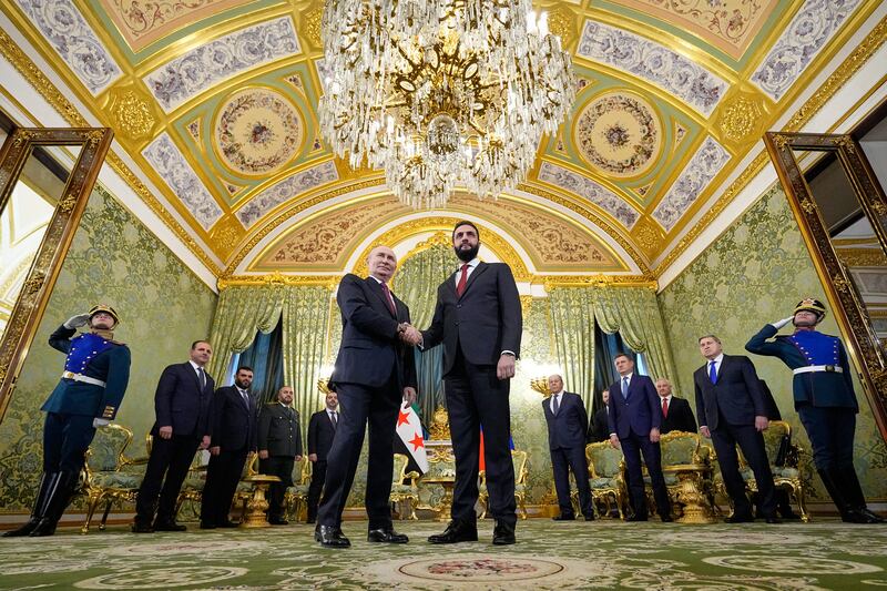 Russian president Vladimir Putin and Syrian president Ahmed al-Sharaa shake hands during their meeting in Moscow on Wednesday. Photograph: Alexander Zemlianichenko/AFP/via Getty Images