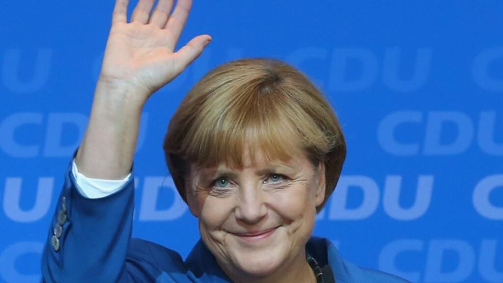 German chancellor Angela Merkel speaks to supporters at CDU headquarters in Berlin yesterday after initial results give the CDU 41.8 per cent of votes cast in the German election. Photograph: Alexander Hassenstein/Getty Images