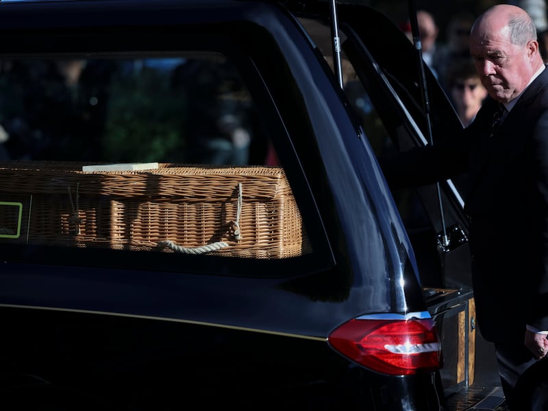 The casket carrying the remains on Manchán Magan outside the church. Photograph: Dan Dennison/The Irish Times
