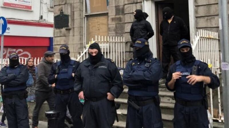 Masked gardaí and private security contractors outside 34 North Frederick Street in Dublin on Tuesday evening. Photograph: Jack Power.