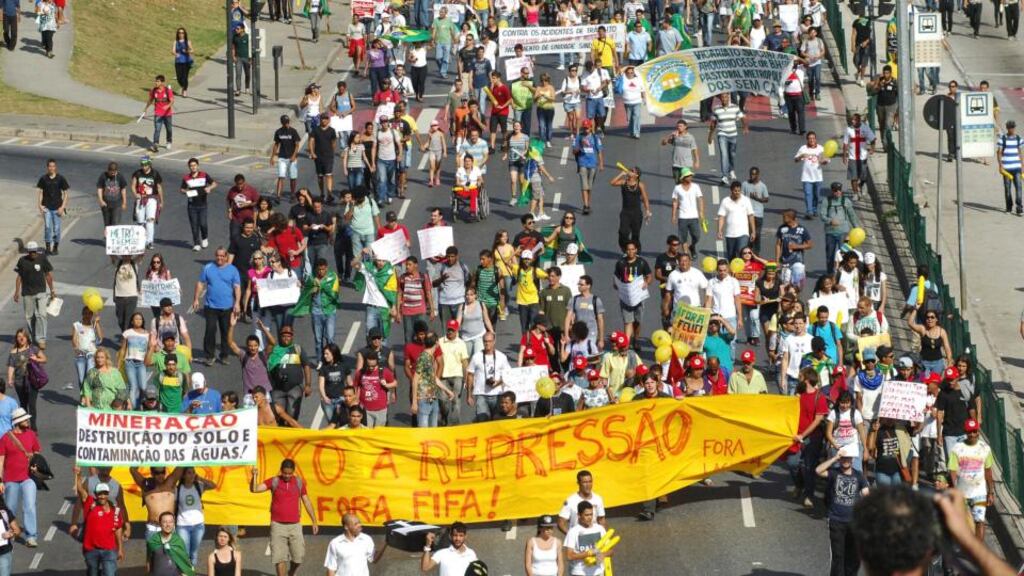 Brazilians participate in a demonstration near the Mineirao Stadium in Belo Horizonte yesterday. The banner reads, “No more repression. FIFA leave.” REUTERS/Jackson Romanelli