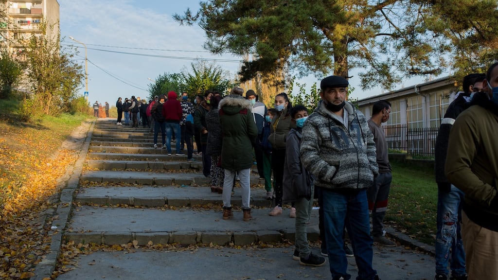 Local residents queue at a school in Kosice, Slovakia, during national testing for Covid-19. Photograph: Zuzana Gogova/Getty Images