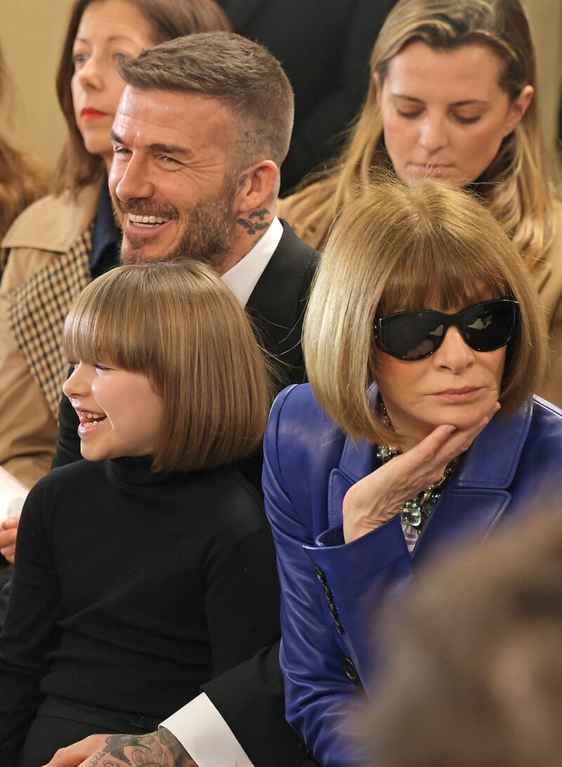 Harper Beckham, David Beckham and Anna Wintour at the Victoria Beckham show during London Fashion Week, February 2019 at Tate Britain. Photograph: David M. Benett/Getty Images