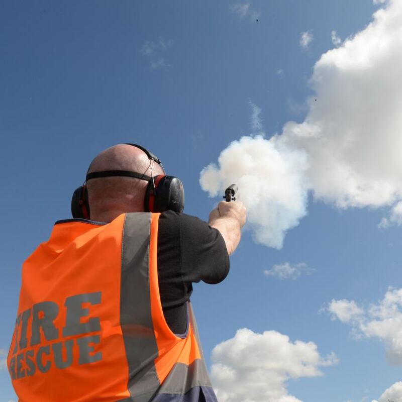 Dublin Aiport: fire officer Ciaran Curran shoots a flare gun to scare birds. Photograph: Dara Mac Dónaill
