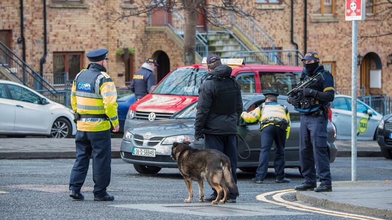 Armed gardaí with sniffer dogs at a major checkpoint on the corner of Bridgefoot Street and Oliver Bond Street in the south inner city on the eve of the funeral of David Byrne in 2016