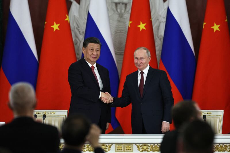 Russian President Vladimir Putin and China's President Xi Jinping shake hands after delivering a joint statement following their talks at the Kremlin in Moscow on March 21, 2023. (Photo by MIKHAIL TERESHCHENKO/SPUTNIK/AFP via Getty Images)