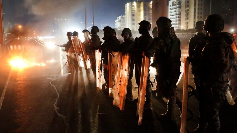 Lebanese army soldiers deploy on a highway that links to the airport, which was blocked by anti-government protesters, during a protest against the new government, in Beirut. Photograph: AP