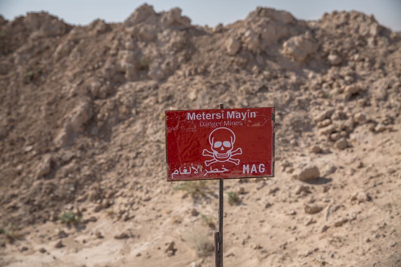 A sign planted by the Mine Advisory Group NGO marks out a minefield in northern Syria. Photograph: Sally Hayden