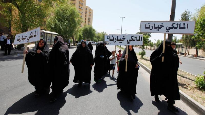 Iraqis carry portraits of incumbent Iraqi prime minister Nuri al-Maliki as they gather in support of him in Baghdatoday. Photograph: Ahmed Saad/Reuters