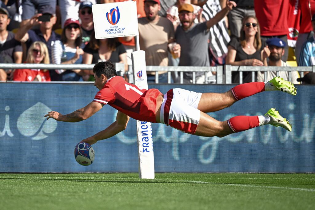 Wales' wing Louis Rees-Zammit dives across the line to score a try against Georgia. Photograph: Loic Venance/AFP via Getty
