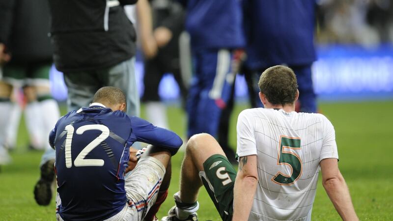 Thierry Henry and Richard Dunne sit on the pitch at the end of the World Cup playoff, second leg at the Stade de France in 2009. Photograph: Franck Fife/AFP via Getty Images
