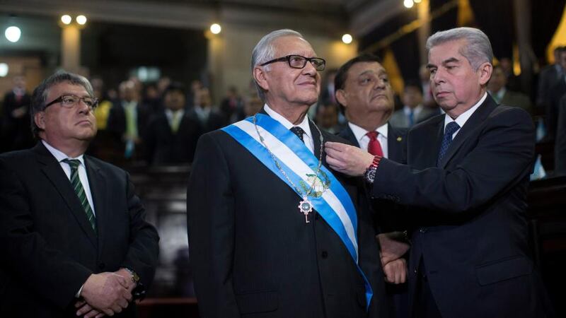Alejandro Maldonado, incoming president of Guatemala, stands while being sworn-in. Photographer: Saul Martinez/Bloomberg