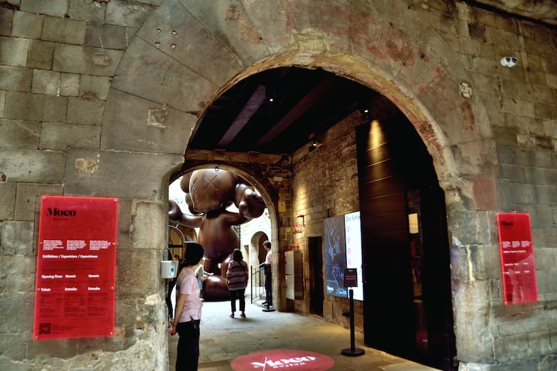 The entrance to Moco Barcelona, where visitors are welcomed by Final Days, a Smurfs-inspired sculpture by US artist Kaws