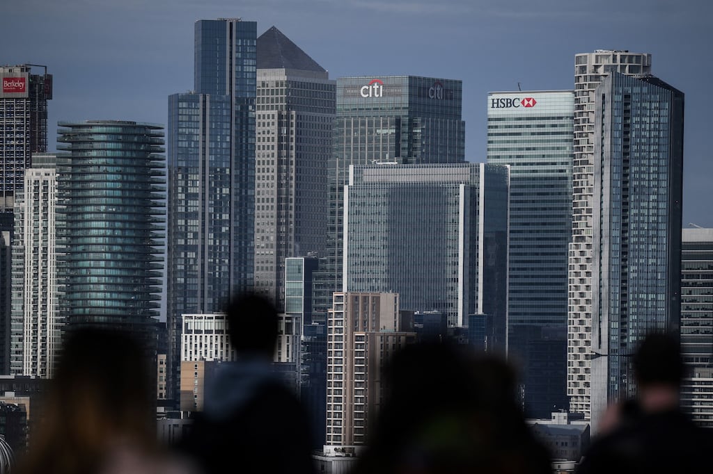 People look at Canary Wharf financial district, from Greenwich Park, south east London. The FTSE 100 briefly cleared 8,000 points on Wednesday. Photograph: Daniel Leal/AFP
