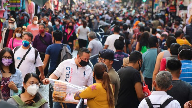 Citizens walk down a busy shopping street in Mexico City on Friday.  The head of Government of Mexico City, Claudia Sheinbaum, warned of a spike in the number of people hospitalised with Covid-19 and asked citizens to stay home during the Christmas holidays, however, she refrained from decreeing closing shops and businesses. Photograph: Jose Pazos/EPA