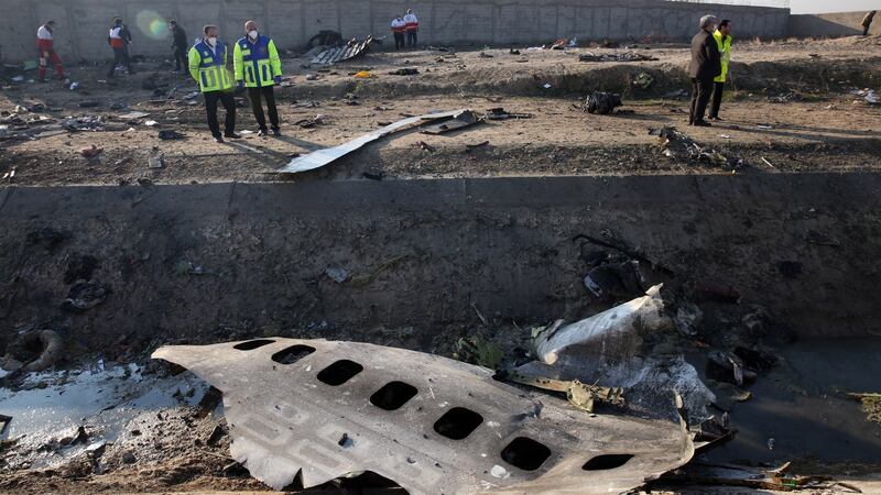 Officials stand near the wreckage after an Ukraine International Airlines Boeing 737-800 carrying 176 people crashed near Imam Khomeini Airport in Tehran, killing everyone on board; in Shahriar, Iran. photograph: Abedin Taherkenareh/EPA