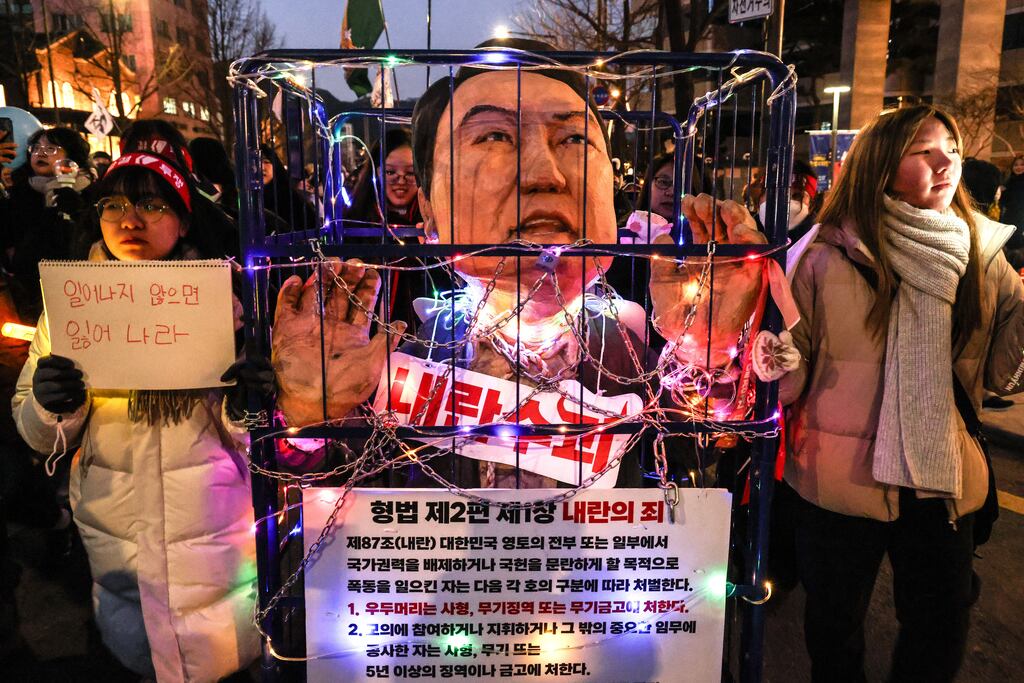 Protesters display a chained effigy depicting impeached South Korean president Yoon Suk Yeol during a rally calling for his resignation in Seoul. Photograph: EPA