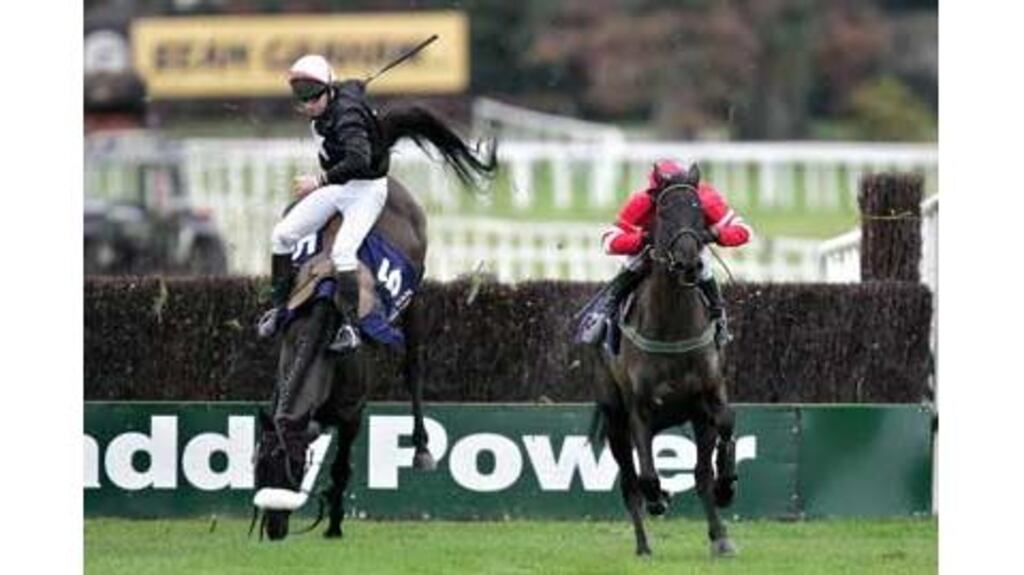 Conor O'Dwyer is unseated by Mansony at the last fence as David Casey on Missed That goes on to win the Durkan New Homes Novice Steeplechase at Leopardstown yesterday.
