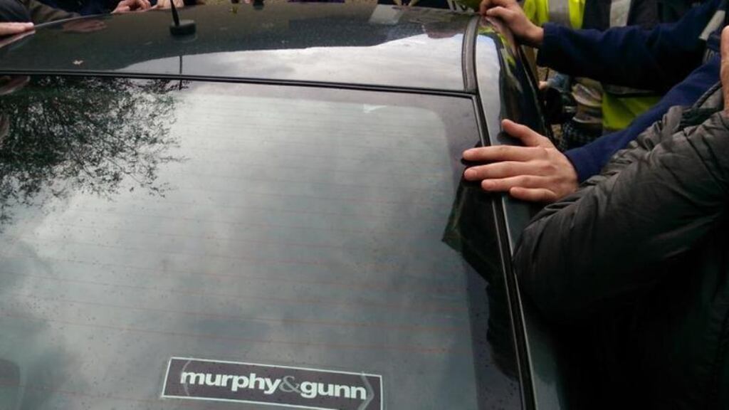 A car carrying Tánaiste Joan Burton is seen surrounded by protestors in Tallaght last weekend.