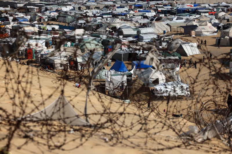 Barbed wire surrounds a camp for displaced people in Rafah, Gaza. Photograph: Mohammed Abed/AFP