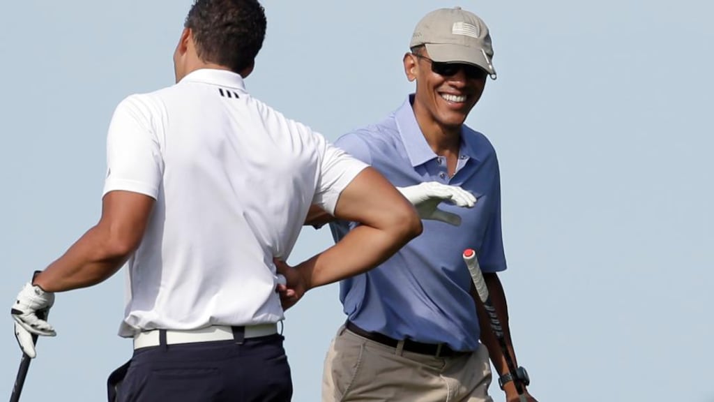President Barack Obama with his Game Golf aid at Vineyard Golf Club. Photograph: AP Photo/Steven Senne