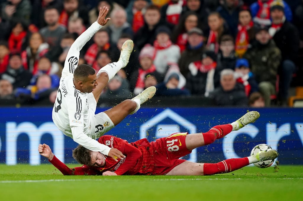 Liverpool's Conor Bradley tackles Real Madrid's Kylian Mbappe during the Champions League game at Anfield on Wednesday night. Photograph: Peter Byrne/PA