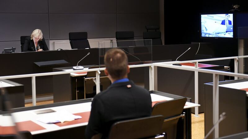Seen on a court video link screen, right, Moroccan man Abderrahman Mechkah, lays in a hospital bed during the initial remand hearing. Photograph: Martti Kainulainen/Lehtikuva/AP