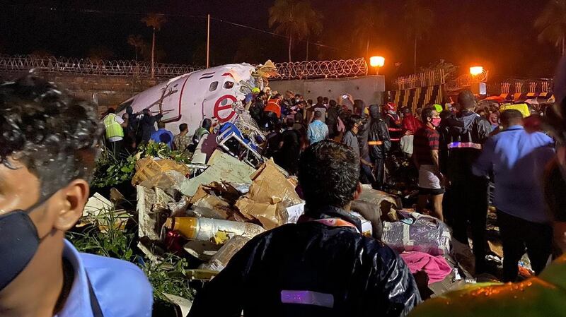 Officials inspect the wreckage site of a plane crash at Calicut airport in Kozhikode, India. Photograph: EPA/Civil Defense