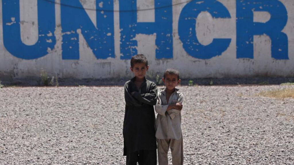 Afghan refugees pose for a photograph as they wait to leave for Afghanistan, at UNHCR registration centre in Chamkani, on the outskirts of Peshawar, Pakistan. Photograph: Arshad Arbab/EPA