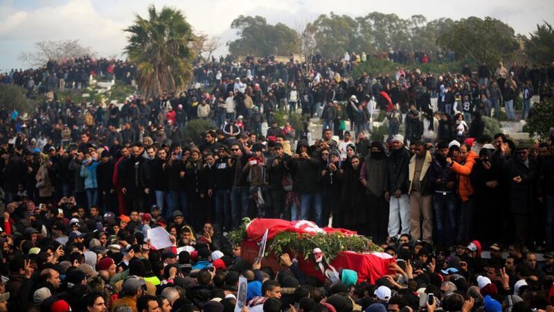 A crowd watches as the coffin of Tunisian opposition politician Chokri Belaid is carried during his funeral in the Jallez cemetery in Tunis in February. Photograph: Tara Todras-Whitehill/The New York Times.