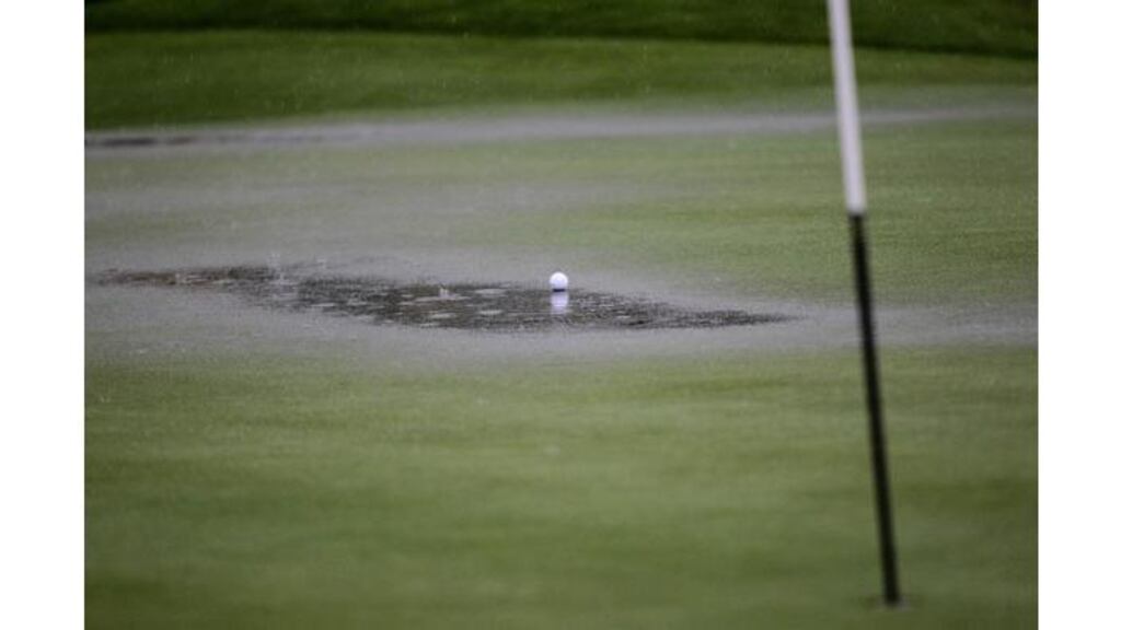 A ball sits in a pool of water on one of the greens at Celtic Manor as heavy rain forces officials to suspend play. Photograph: David Davies/PA Wire