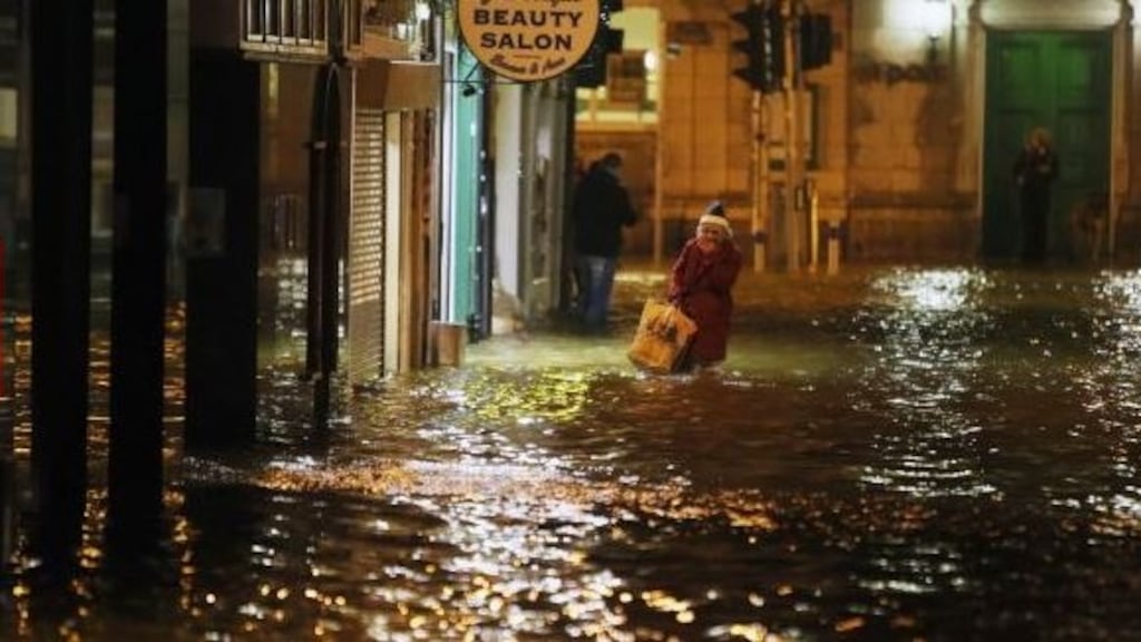 A woman makes her way through flood waters in Cork city on February 4th, 2014. File photograph: Niall Carson/PA Wire