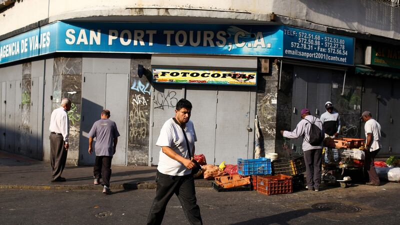People on the streets of Venezuela’s capital Caracas on Wednesday as businesses remained closed during a continuing blackout. Photograph: Cristian Hernandez/AFP/Getty Images