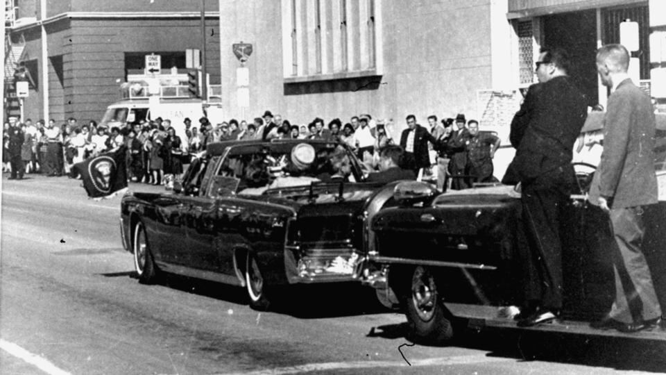 The presidential limousine  is followed by secret servicemen on running boards. Photograph: AP