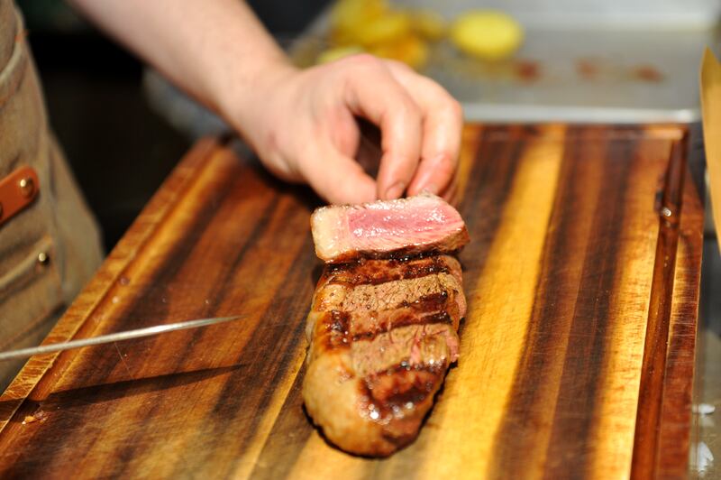 Chef Victor Franca slices the renowned cooked beef at Nua Asador, atCork's Marina Market. Photograph: Larry Cummins