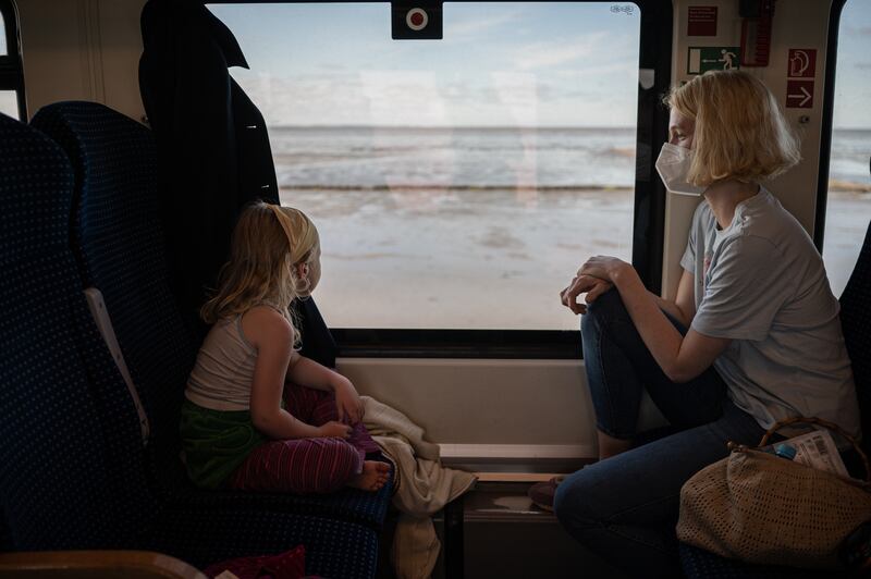 Josefine Witt and her daughter on the regional train to Westerland, Germany. Photograph: Lena Mucha/The New York Times