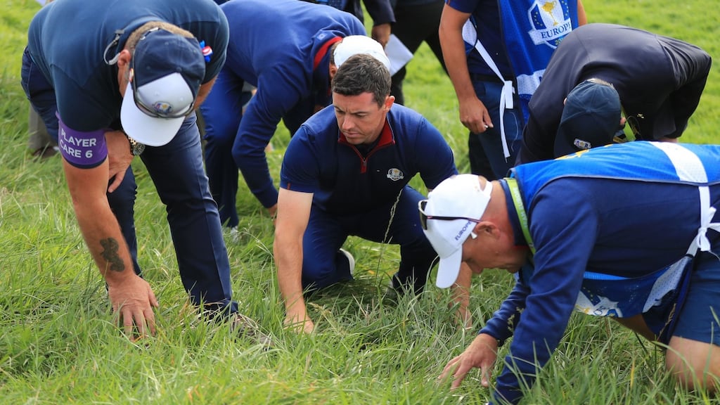 Team Europe’s Rory McIlroy looks for his ball on the ninth hole during the fourballs match on day one of the Ryder Cup. Photograph: PA