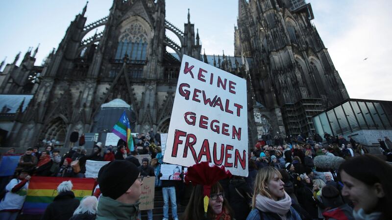 A demonstrator holds a sign in German that reads ‘No violence against women’ during a demonstration in the wake of the sexual assaults on New Year’s Eve, outside the cathedral in Cologne, Germany on Saturday. Photograph: Oliver Berg/EPA