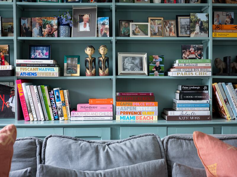 Jessica loves to print and frame photos and switches them around regularly. They fill the shelves of the bespoke cabinetry, painted Dulux Heritage Rosemary Leaf