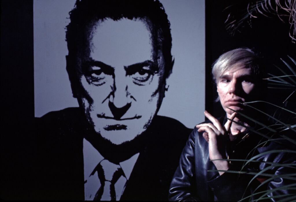 Andy Warhol in 1968 with his silkscreen of Sidney Janis, a prominent art collector and gallery owner. Photograph: Jack Mitchell/Getty