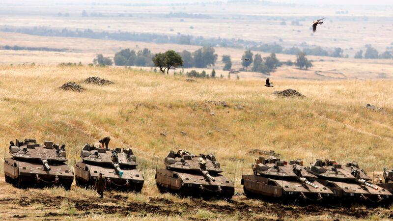 Israeli Merkava tanks in a deployment area near the Syrian border in the Israel-annexed Golan Heights on Thursday. Photograph: Menahem Kahana/AFP/Getty Images