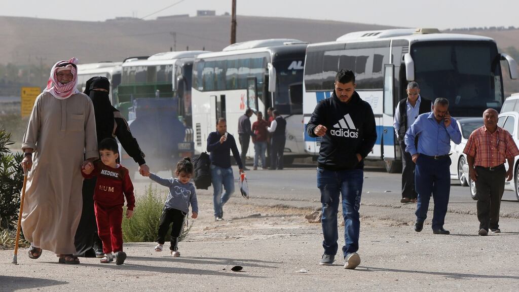 People walk as they wait to travel to Syria at Jordan’s Jaber border crossing, near Syria’s Nassib checkpoint, in Jordan, on October 25th, 2018. Photograph: Muhammad Hamed/Reuters