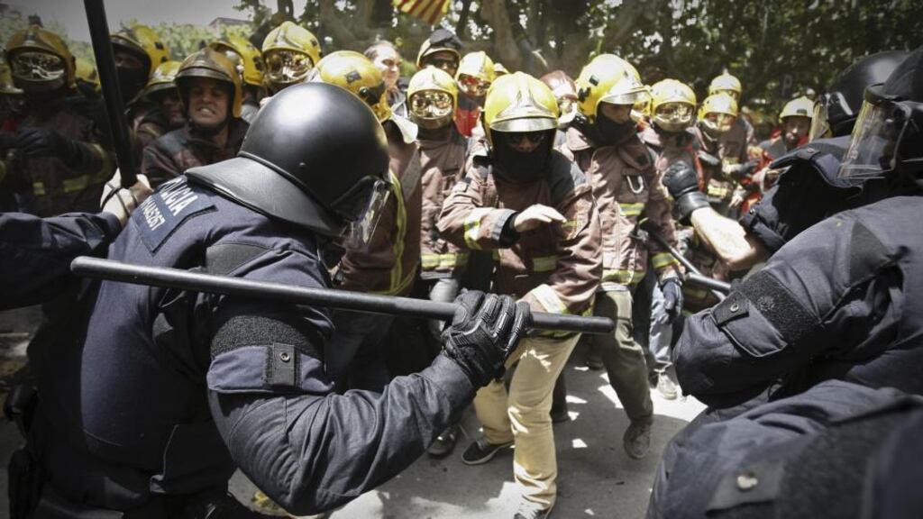 Spanish riot police charge firefighters during a protest against austerity measures in front of the Catalonian parliament in Barcelona yesterday. Photograph: Paco Serinelli/AP