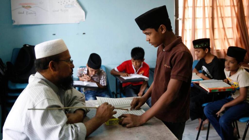 A Rohingya Muslim boy recites verses from the Koran at a privately run school for Rohingya children refugees and asylum seekers in Kuala Lumpur. The Rohingya people of Burma remain almost entirely unrecognised by their own government. They are denied citizenship and may not travel freely. Photograph: Olivia Harris