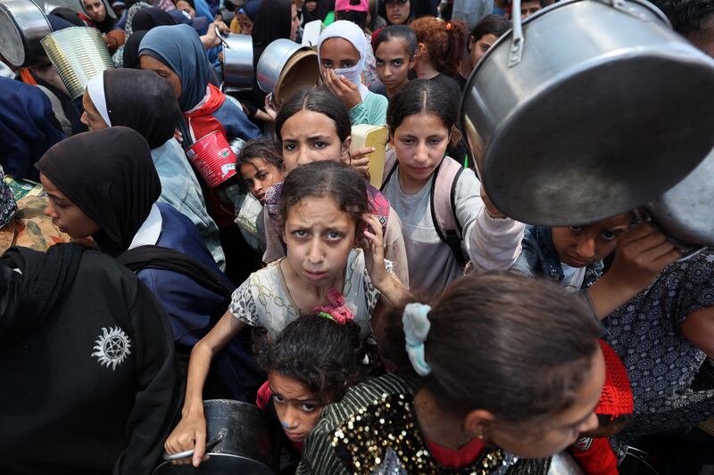 Palestinian children gather at a hot meal distribution point in Nuseirat in the central Gaza Strip. Photograph: Eyad Baba/AFP via Getty Images